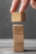 wooden-blocks-plain-table-background-with-hand-finger (1) (1)